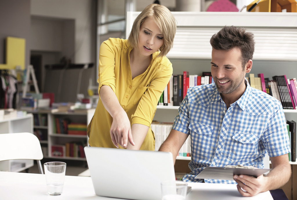 Male and Female colleagues looking at laptop