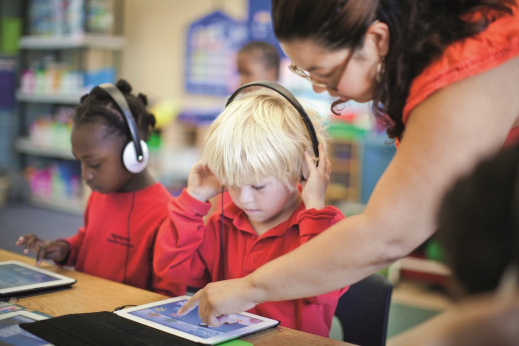 nursery child using tablet and earphones