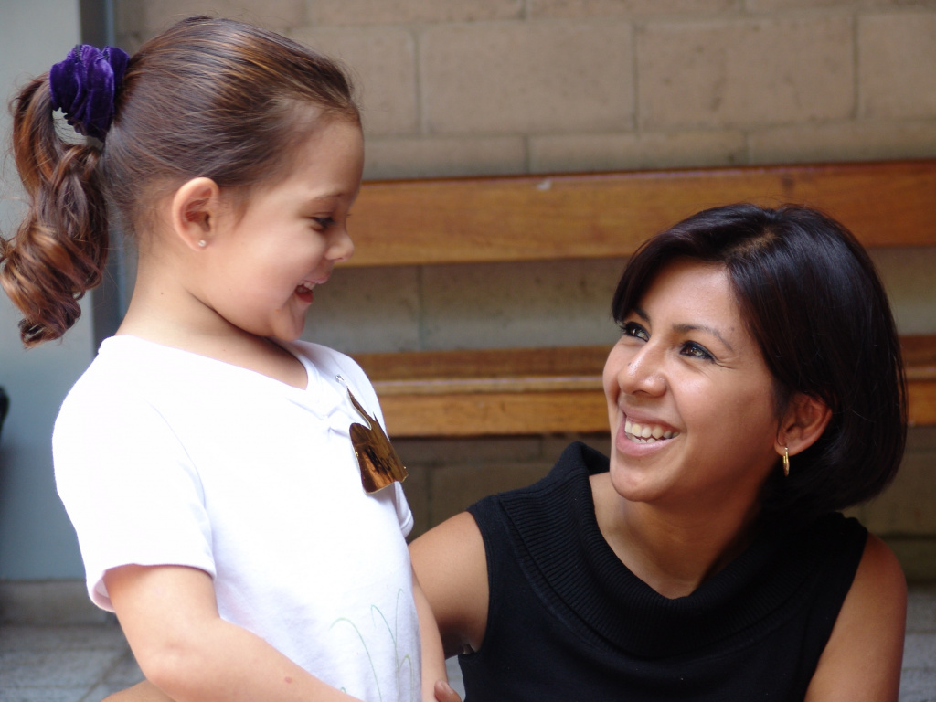 Woman with pre-school girl smiling