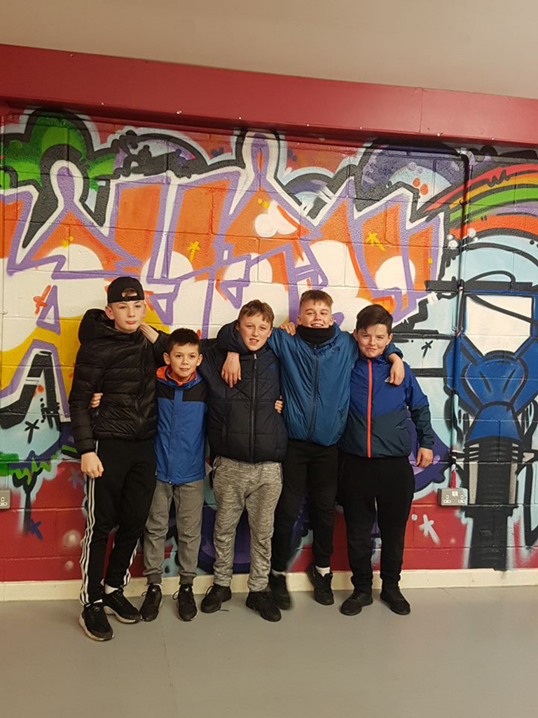 teenage boys against wall