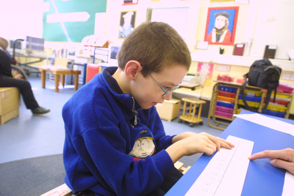 SEN boy reading number cards