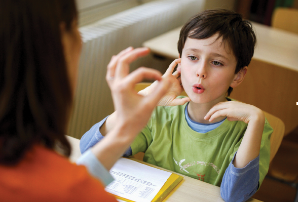 Young boy with teacher learning language skills