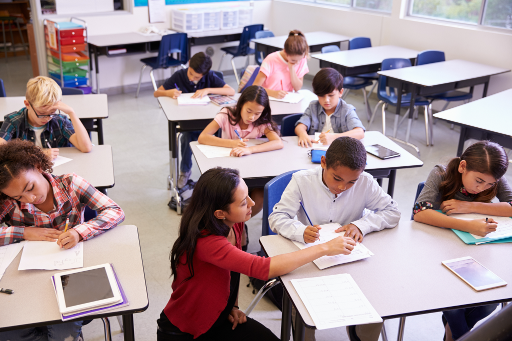 Teacher helping pupil