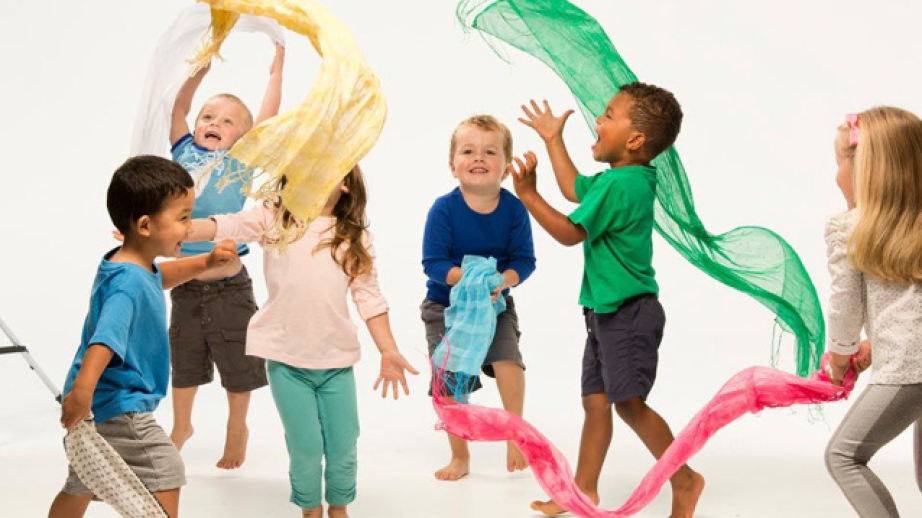 Children playing with fabric