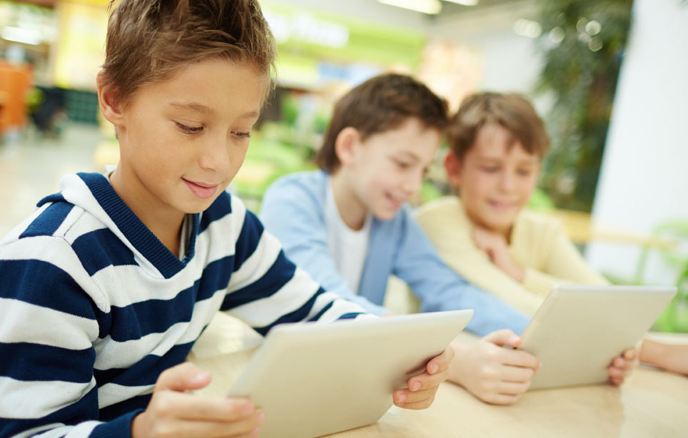 Children looking at tablets