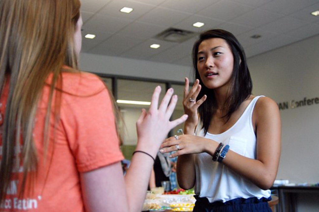 young adult girls signing to each other