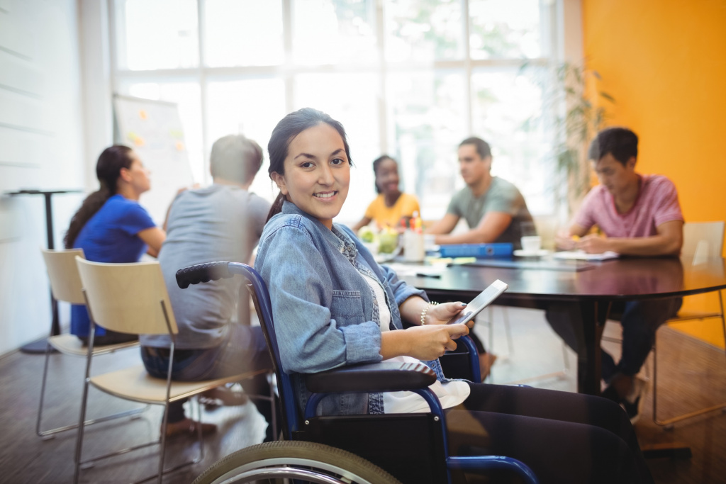 business executive in wheelchair using digital tablet