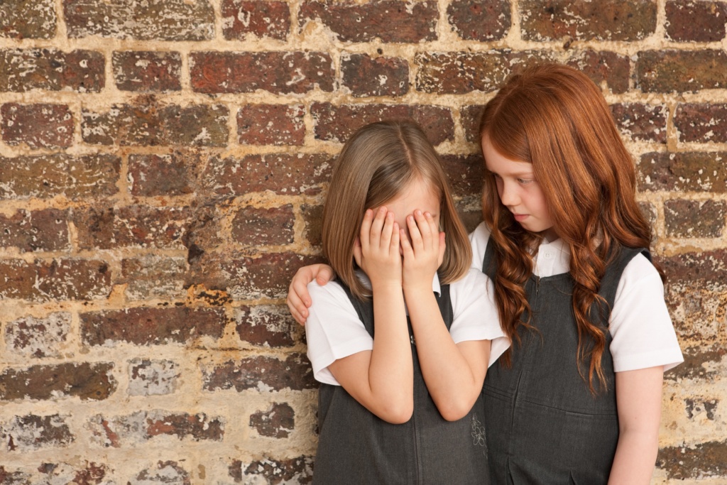 Girl comforting her friend