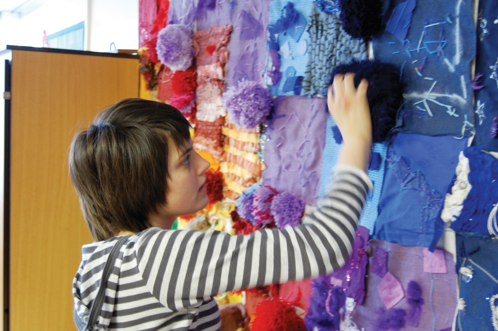 Autistic pupil playing with sensory wall