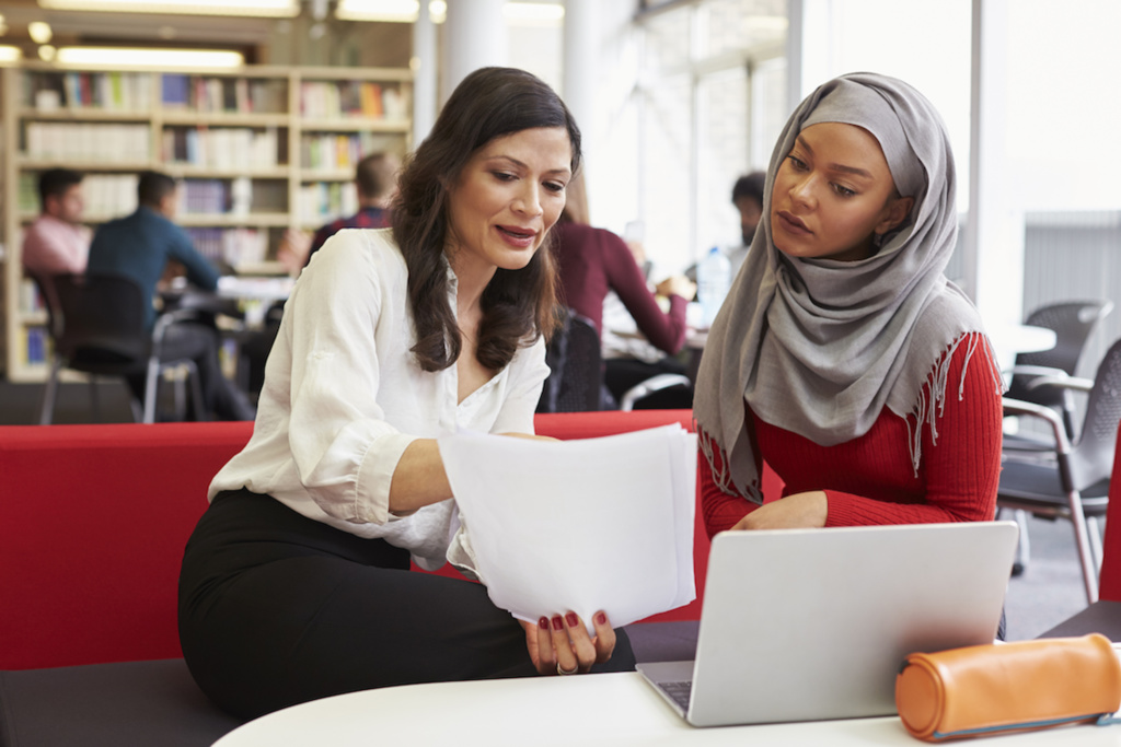 Two teachers collaborating on a piece of work