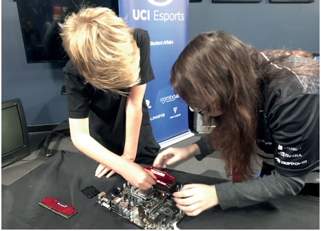 Students replacing components of a motherboard