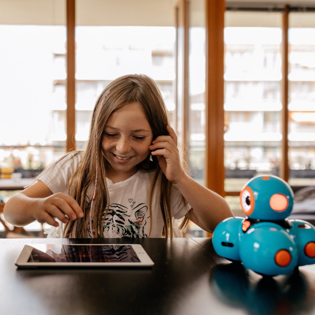 Girl with tablet and robot