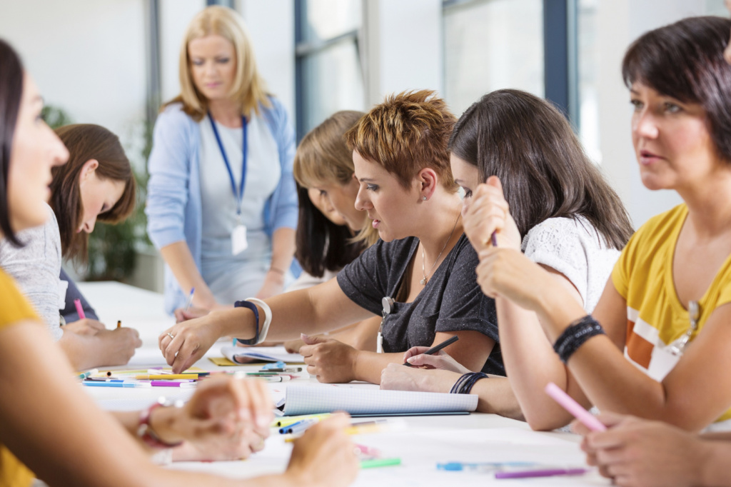 women staff around desk in discussion