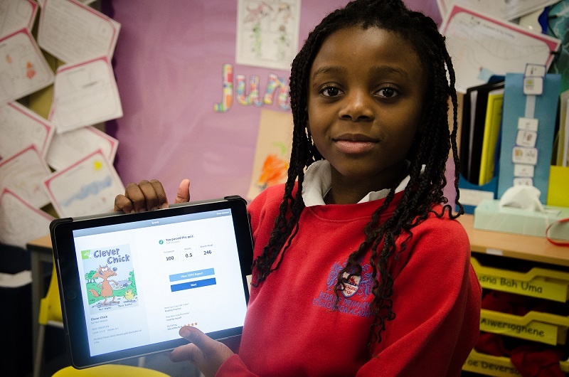 Girl proudly showing screen on her tablet