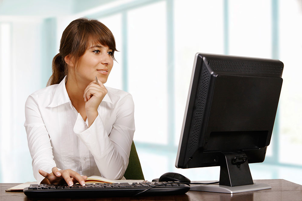 Young woman in an office using a computer