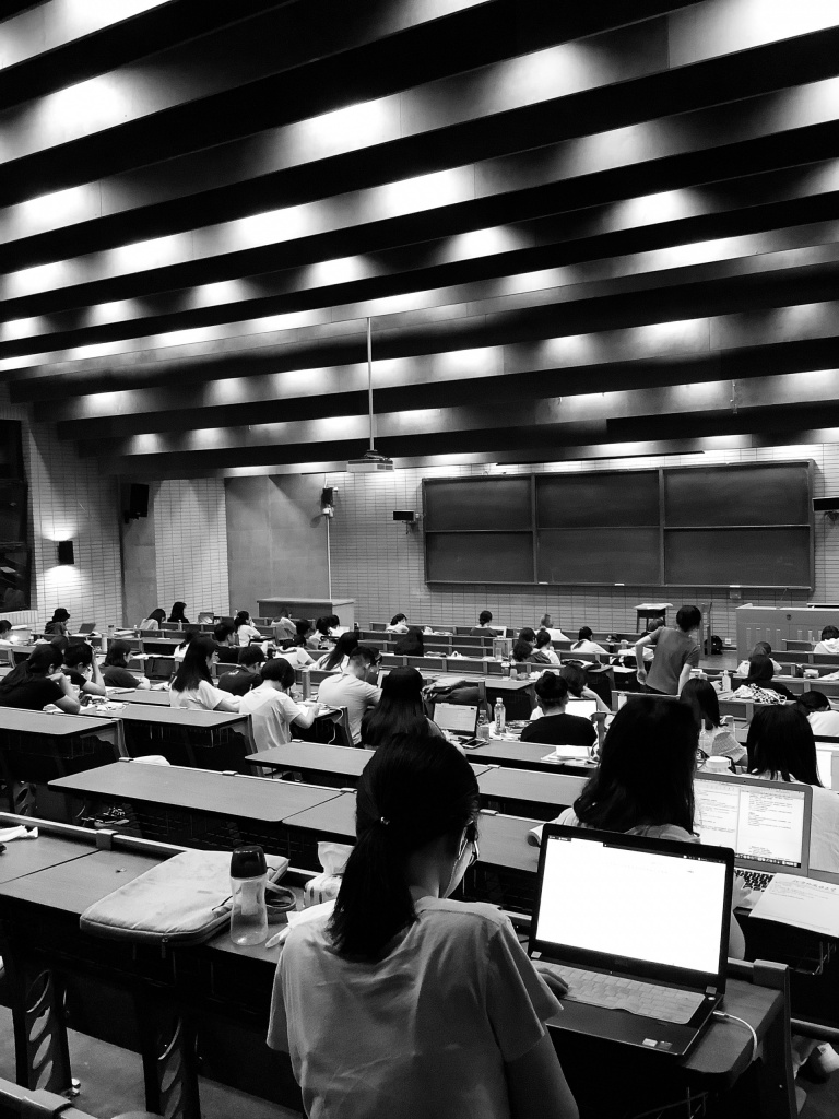 black and white image of students with laptops