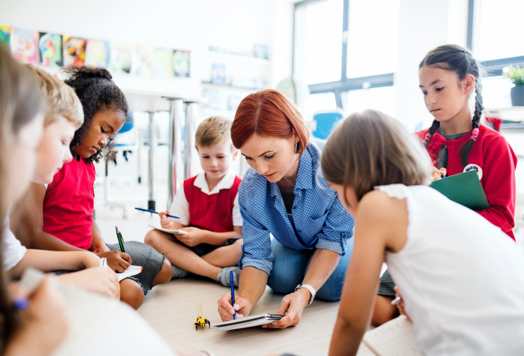 Elementary school teacher listening to her pupils