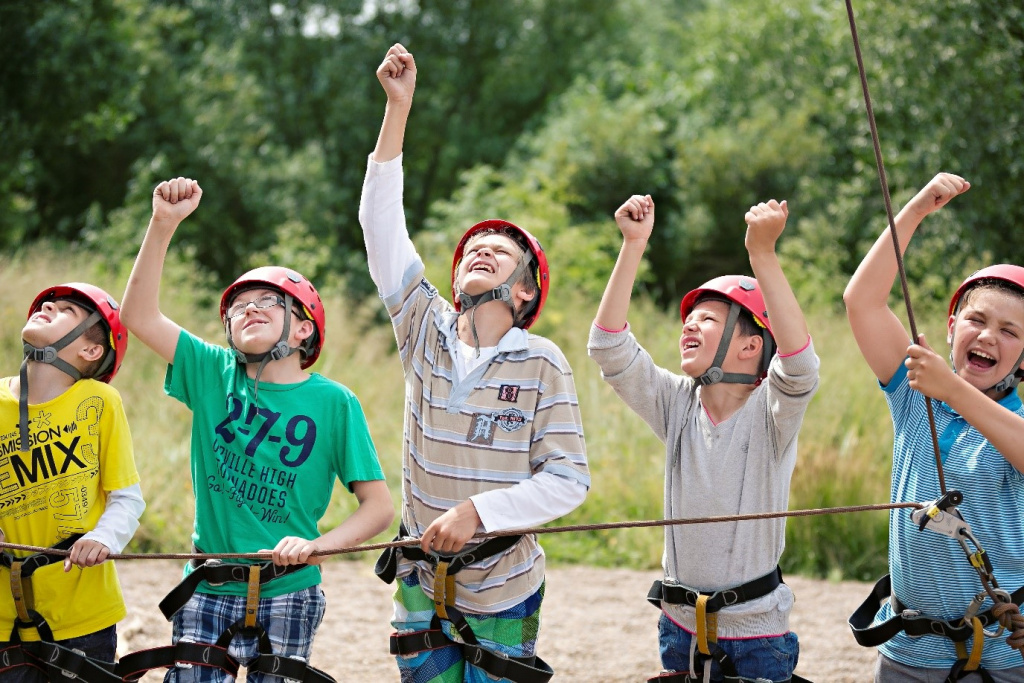 Cheering school boys doing an outdoor activity.