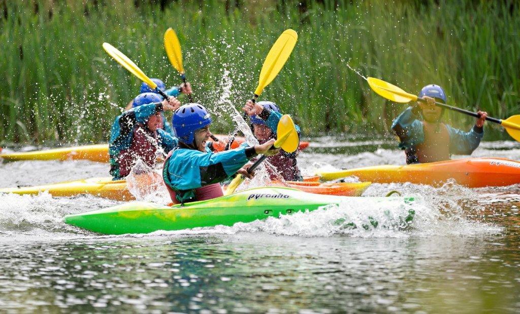 Secondary school students in canoes.