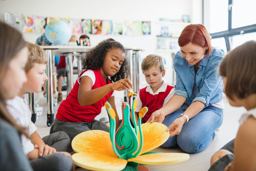 Teacher playing with primary school children.