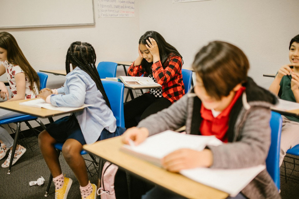 Dyslexic elementary school girl reading at her desk