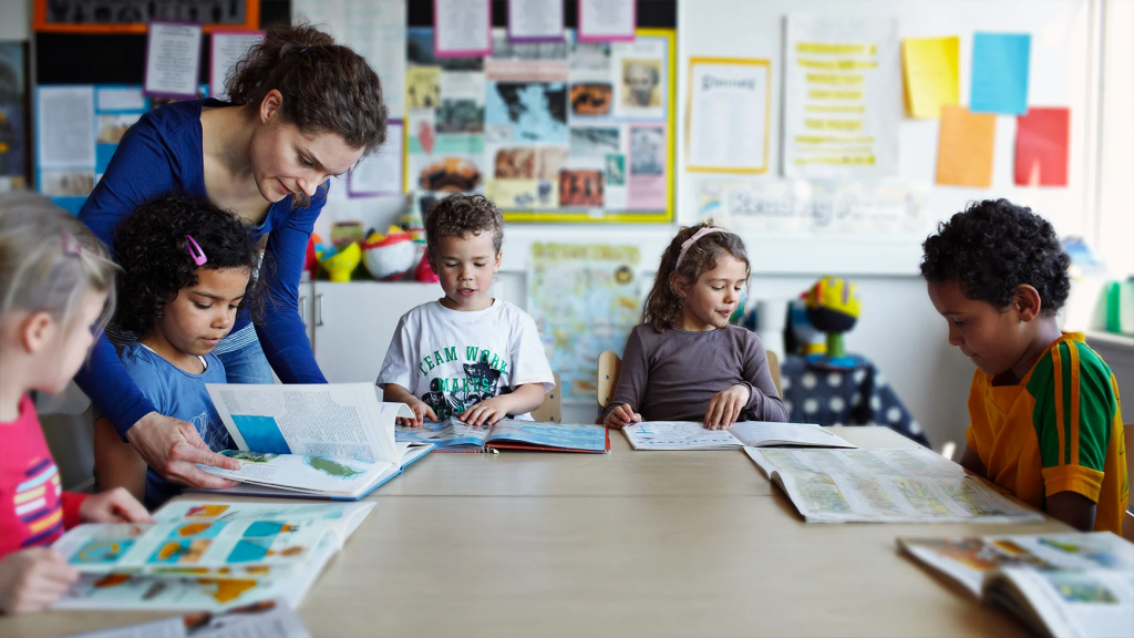 Elementary school students learning words from English textbook