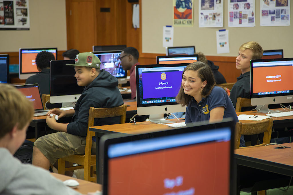 Secondary school students using computers with Kahoot.